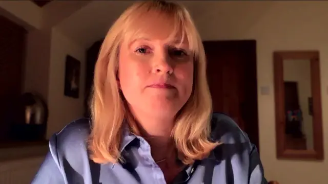 Rosie Duffield wears a violet silk shirt and is speaking to the BBC from her home via Zoom