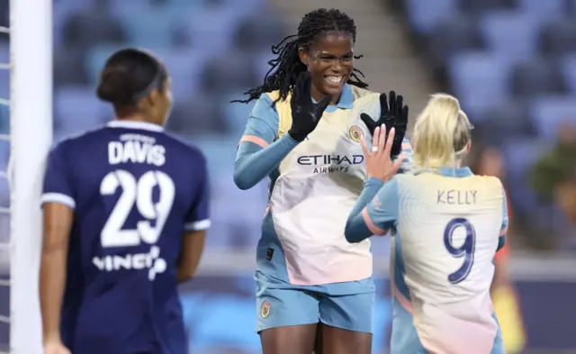 Khadija Shaw of Manchester City celebrates scoring her team's second goal with teammate Chloe Kelly