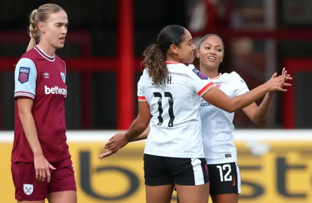 Olivia Smith of Liverpool celebrates scoring her team's first goal with teammate Taylor Hinds