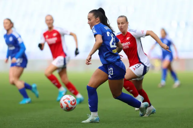 Yuka Momiki of Leicester City runs with the ball under pressure from Beth Mead