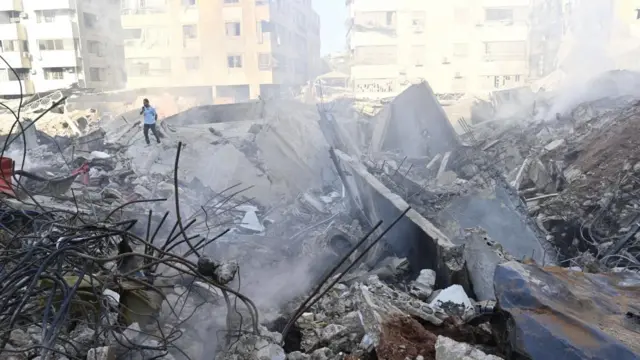 A man inspects destroyed buildings in the Haret Hreik neighborhood of Beirut's southern suburbs, after Israeli military strikes on Beirut, Lebanon