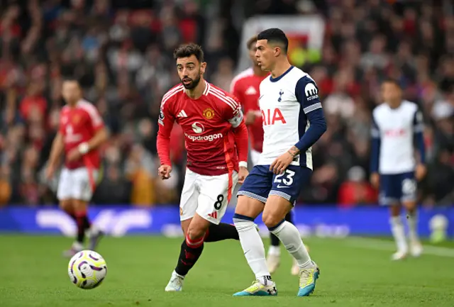 Pedro Porro of Tottenham Hotspur passes the ball under pressure from Bruno Fernandes