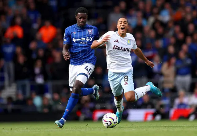 Youri Tielemans of Aston Villa is challenged by Axel Tuanzebe