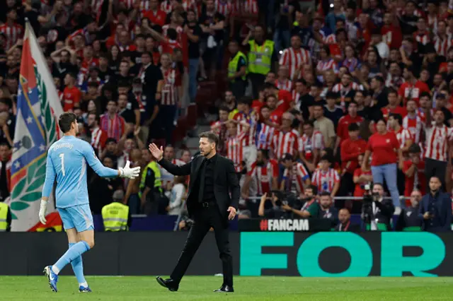 Diego Simeone shakes hands with Real Madrid's Belgian goalkeeper #01 Thibaut Courtois