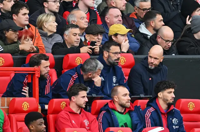 Erik ten Hag, Manager of Manchester United, interacts with his backroom