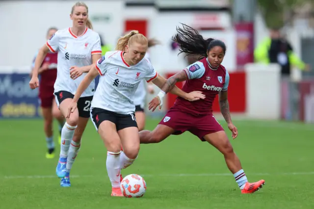 Ceri Holland battles for possession with Manuela Pavi