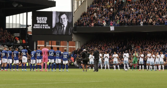 Players applaud during the applause for former Ipswich Town club secretary David Rose