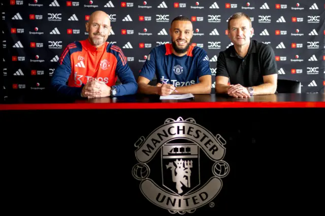 Noussair Mazraoui of Manchester United poses with Erik ten Hag and  Dan Ashworth