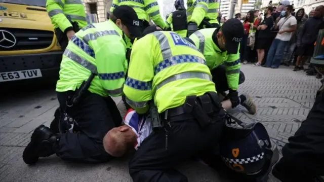 Man being held down by police during protests in Liverpool