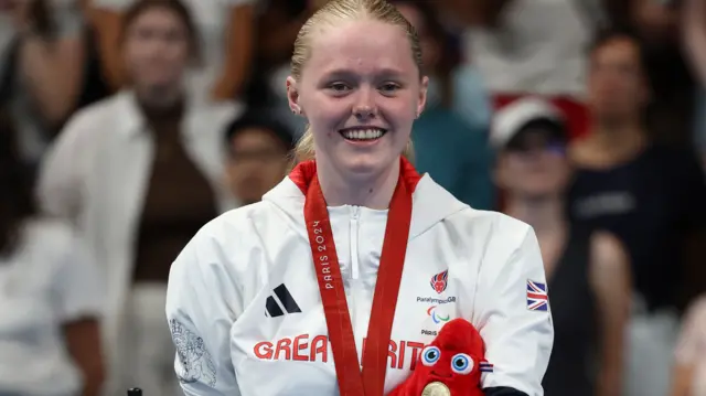 Ellie Challis on the podium with her Paralympic gold medal