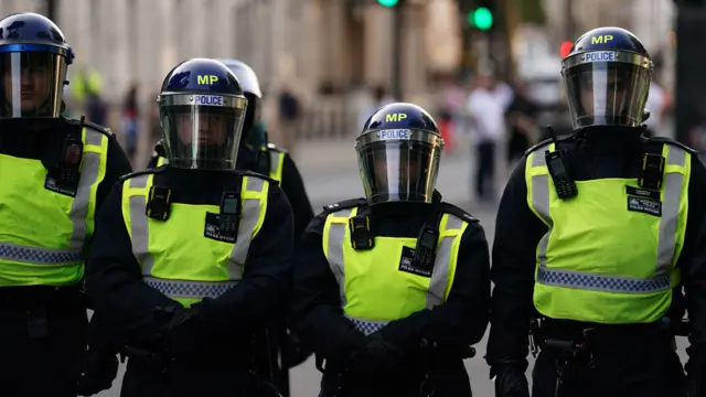 Four police officers wearing protective gear