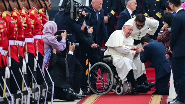 Pope Francis is welcomed as he arrives at Soekarno-Hatta International Airport near Jakarta