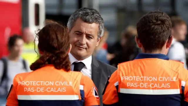 French Interior Minister Gerald Darmanin speaks with first responders after several migrants died as their boat capsized on its way across the Channel to Britain, in Boulogne-sur-Mer, France, September 3, 2024.