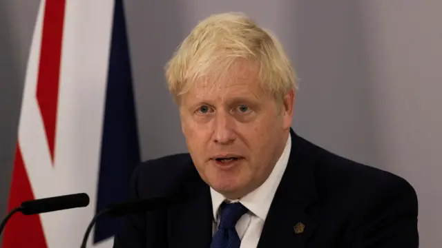 British Prime Minister Boris Johnson attends a news conferenc