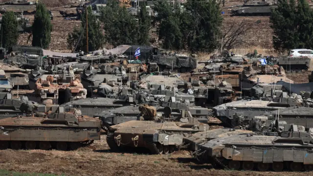 A group of tanks, some with Israeli flags on them