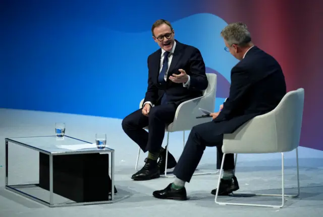 Tom Tugendhat and Christopher Hope sitting on chair on stage at party conference