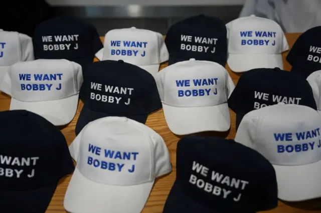 Baseball caps supporting Conservative leadership contender Robert Jenrick are seen during the Conservative Party Conference at Birmingham ICC Arena on September 30, 2024 in Birmingham, England.