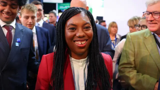 Kemi Badenoch smiles alongside attendees at the Conservative Party conference