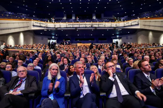 Delegates attend the Britain's Conservative Party's annual conference in Birmingham