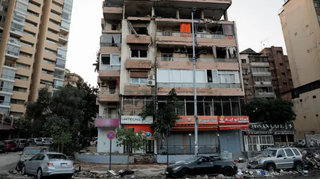 An exterior of a damaged apartment building in Beirut's Kola district