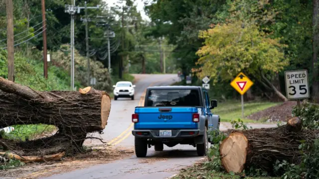 A fallen tree across a road after Hurricane Helene