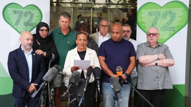 Natasha Elcock reading a statement, other members of Grenfell United are standing behind her