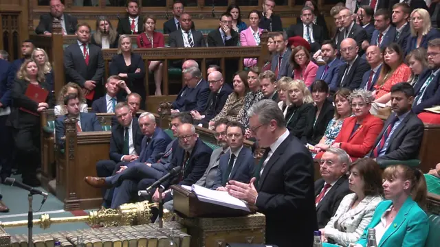 Keir Starmer speaking in the House of Commons, the benches behind him are full with Labour MPs