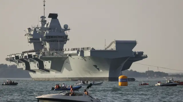 Royal Navy handout photo of the HMS Queen Elizabeth enters the Solent off of Cowes and conducts a gun salute in front of the Royal Yacht Squadron.