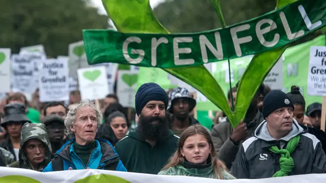 People holding 'justice for Grenfell' banners march