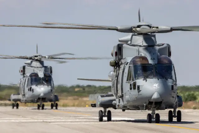 Two Mk-4 helicopters are seen on the runway