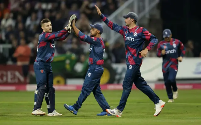 Saif Zaib (C) of Northamptonshire Steelbacks celebrates with team mates after catching out Tom Kohler-Cadmore