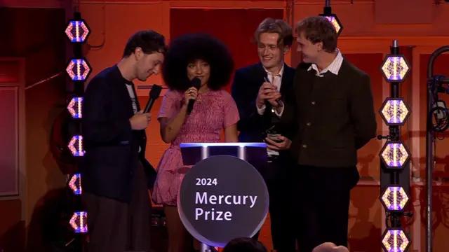 The four band members of English Teacher stand at the podium for the Mercury Prize on stage