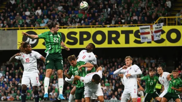 Ciaron Brown sends a header towards the Luxembourg goal at Windsor Park