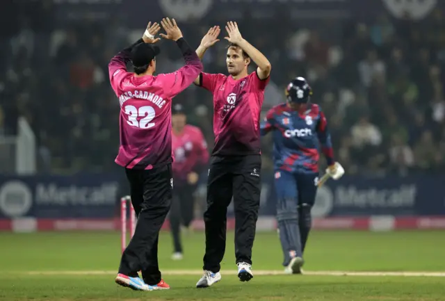 Lewis Gregory of Somerset celebrates with team mate Tom Kohler-Cadmore after catching out Justin Broad