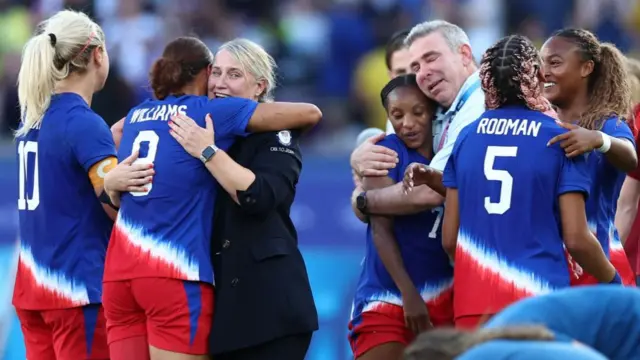 Emma Hayes celebrates with the United States women's team after leading them to a gold medal at the Paris Olympics