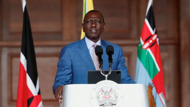 William Ruto standing at a lectern speaking