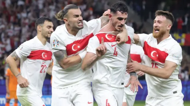 Samet Akaydin celebrates with Kaan Ayhan and Salih Özcan after scoring in Turkey's Euro 2024 quarter-final against the Netherlands