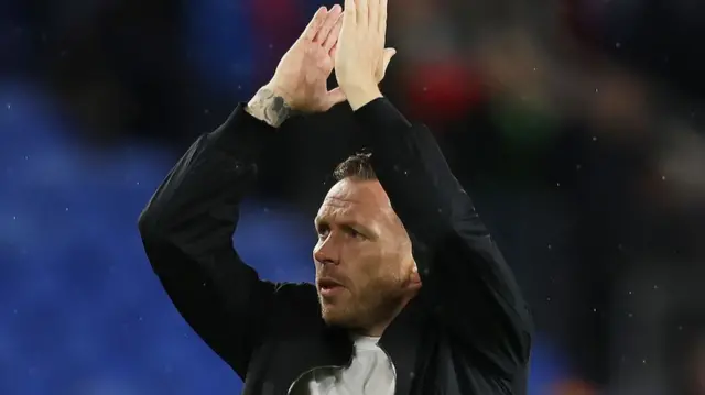 Craig Bellamy claps the fans