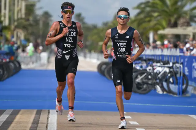 Alex Yee of Great Britain is on his way to winning the men's race from Hayden Wilde of New Zealand