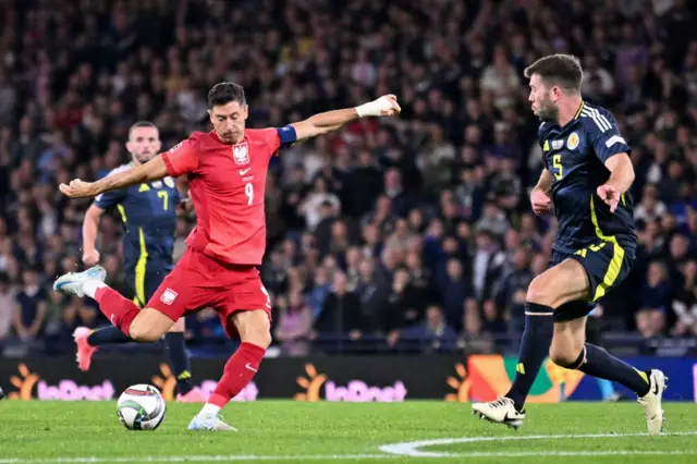 Robert Lewandowski attempts a shot at goal against Scotland