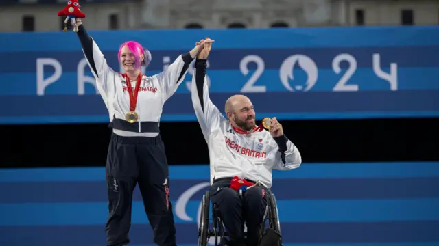 Jodie Grinham and Nathan Macqueen celebrate Para-archery gold