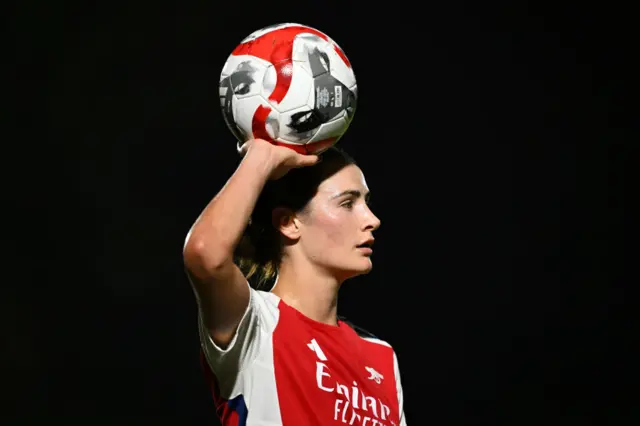 Fox holds the ball above her head as she prepares to take a throw