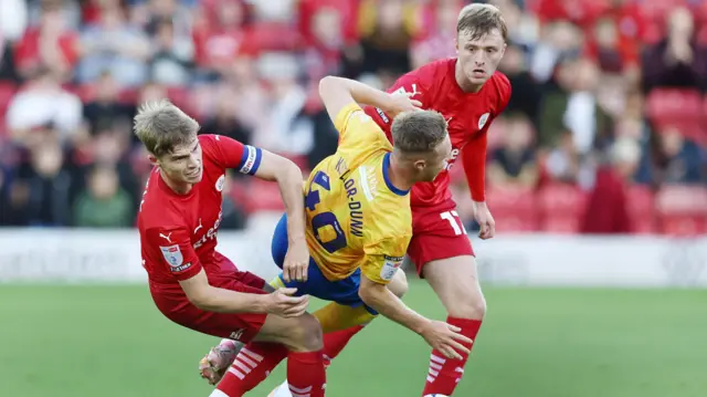 Davis Keillor-Dunn being challenged by two Barnsley players