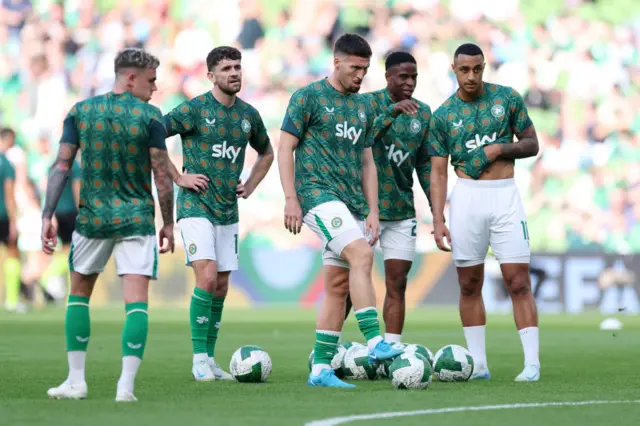 Ireland players warm up for the game with a shooting drill