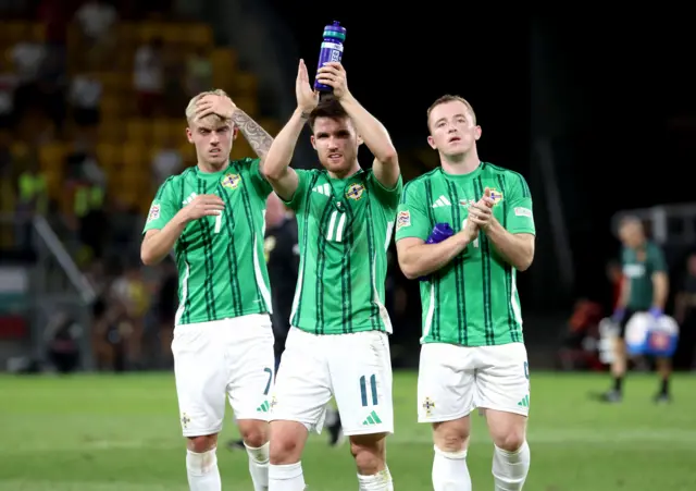 Northern Ireland players applaud fans after the game