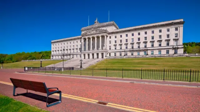 The front of the Stormont building. The sky is blue in the background.