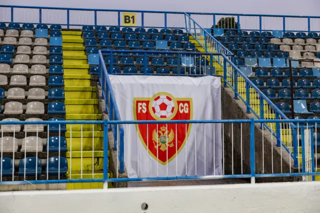 A Montenegro football crest flag in the stand