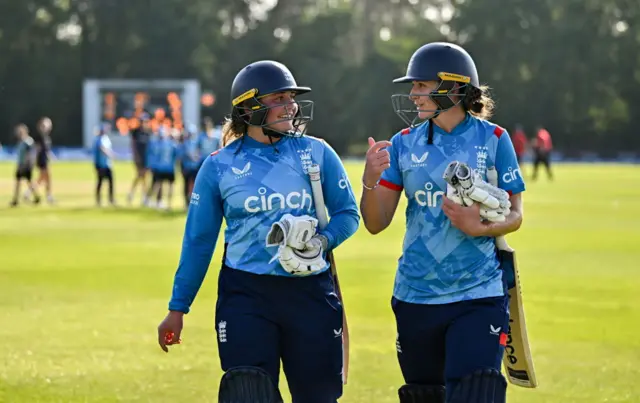 Bess Heath (left) and Kate Cross leave the field after beating Ireland