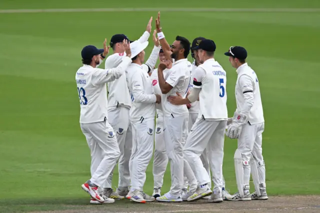 aydev Unadkat of Sussex (centre) celebrates with team mates after dismissing Asa Tribe of Glamorgan during the Vitality County Championship Division 2 match between Sussex and Glamorgan