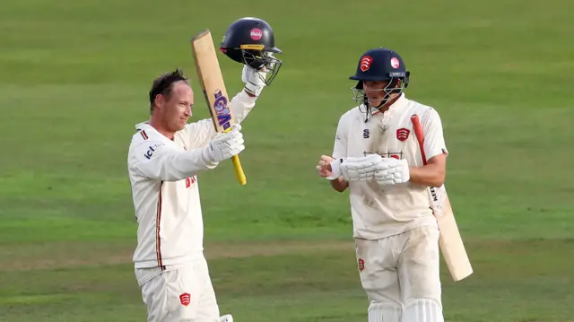 Tom Westley of Essex raises his bat after reaching his century
